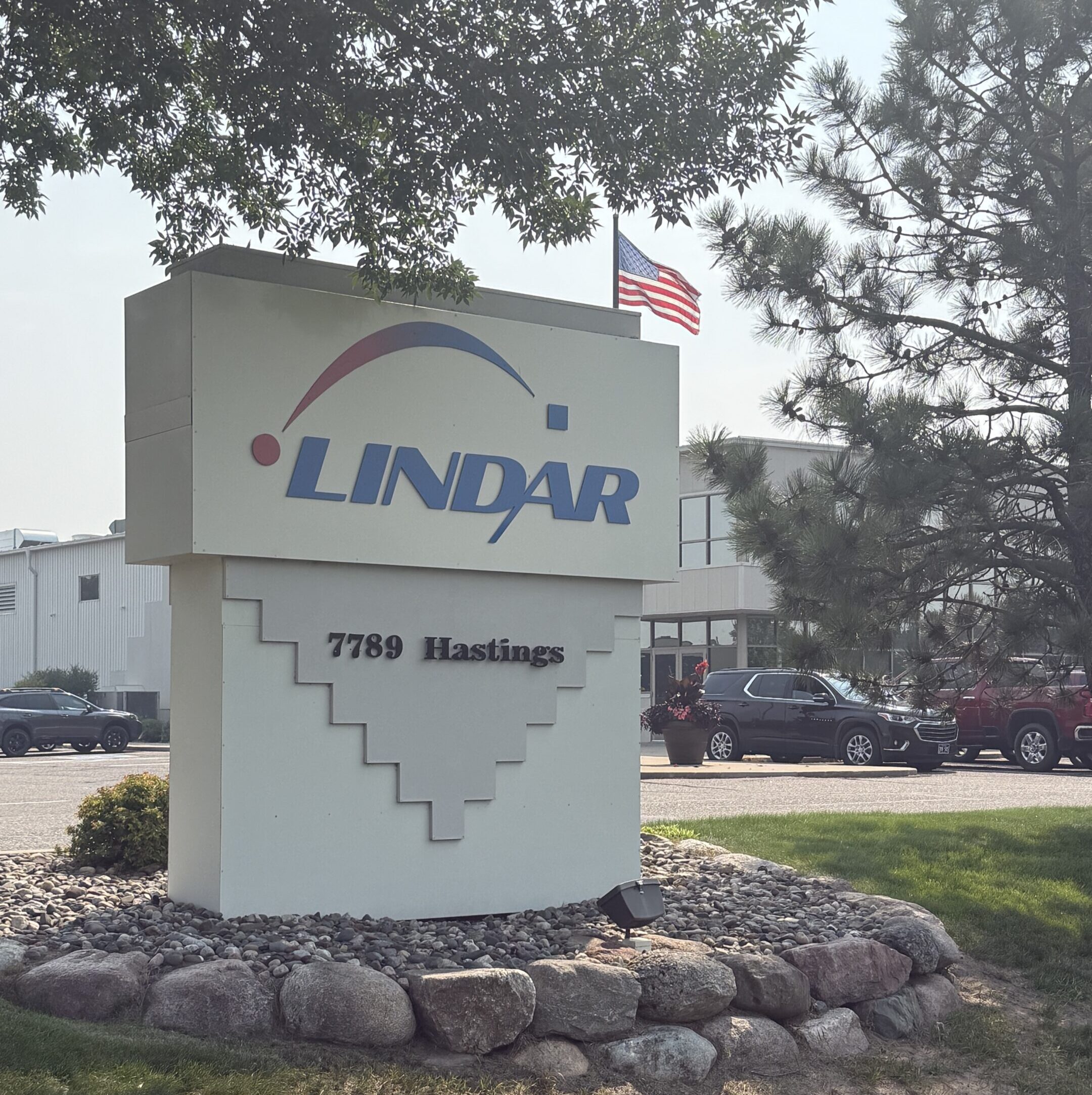 Two guys laughing and smiling while looking at laptop